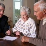 Trimnal & Myers, elderly couple signing papers